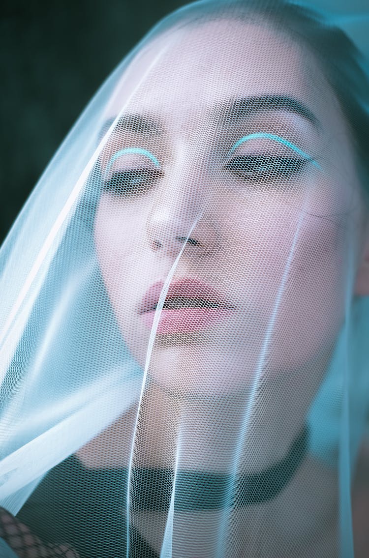 Portrait Of A Young Woman Wearing A Veil Over Her Face