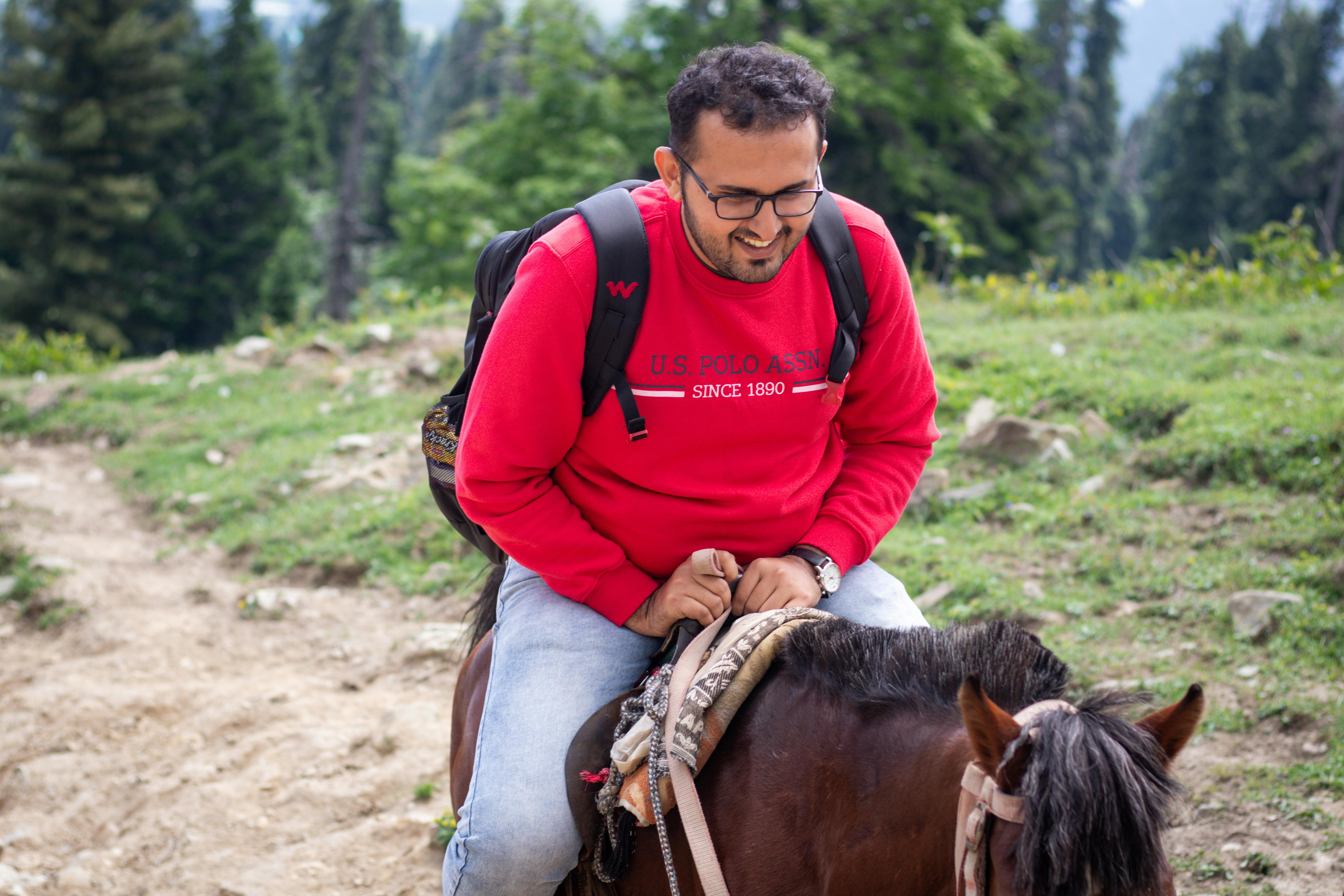 Tourist with a Backpack Riding a Horse · Free Stock Photo