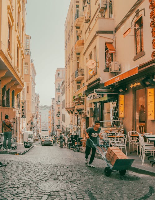 A Cobblestone Street between Apartment Buildings in City 