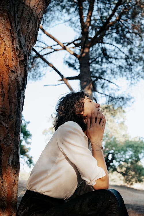 Sitting under Tree Woman Holding Chin between Hands