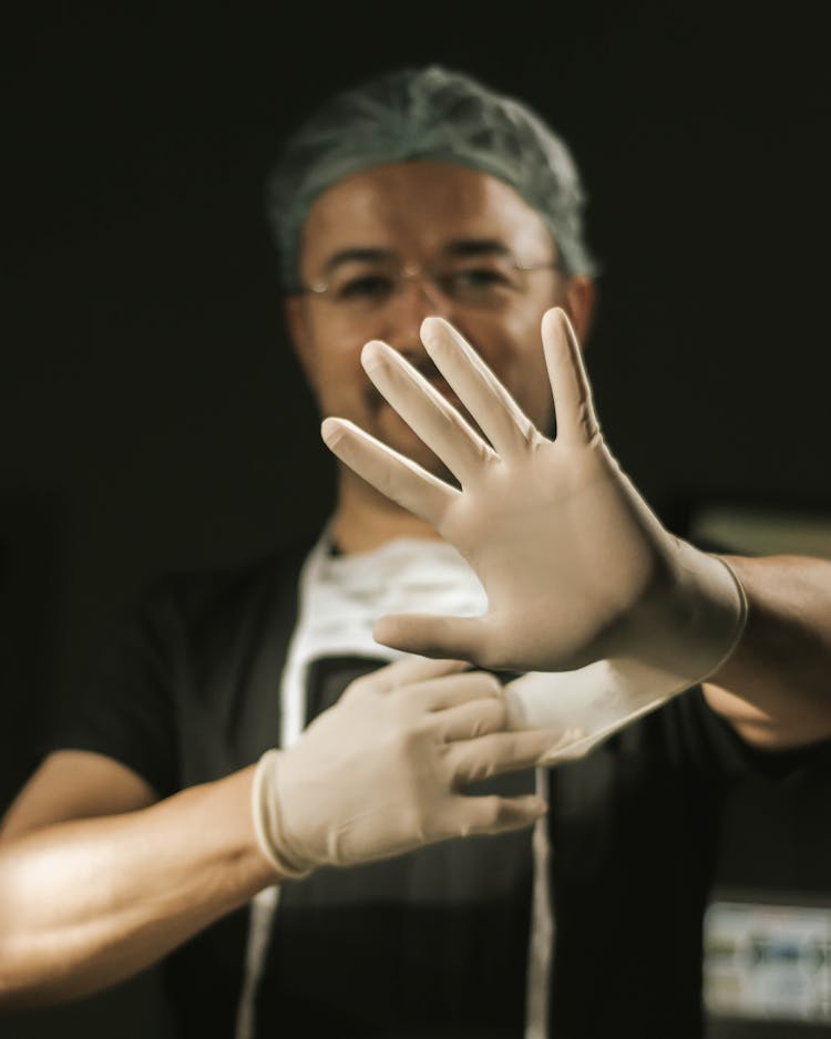 Close Up Of Doctor Wearing Gloves