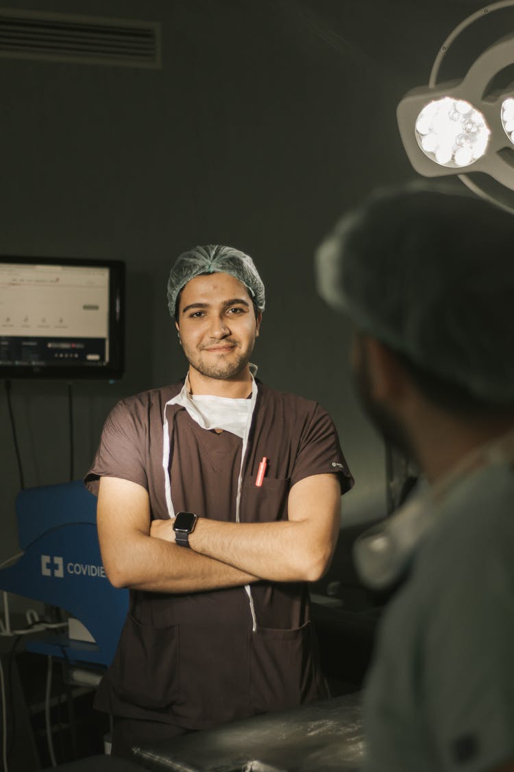 Smiling Doctor Standing With Arms Crossed