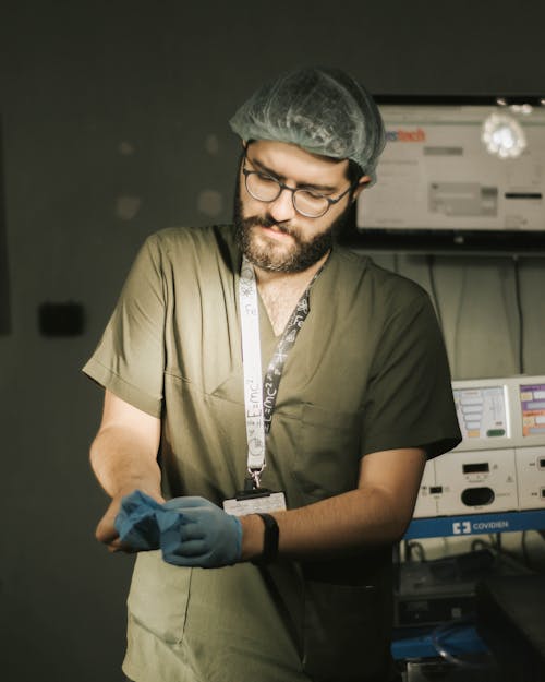 Bearded Man Putting on Surgical Gloves