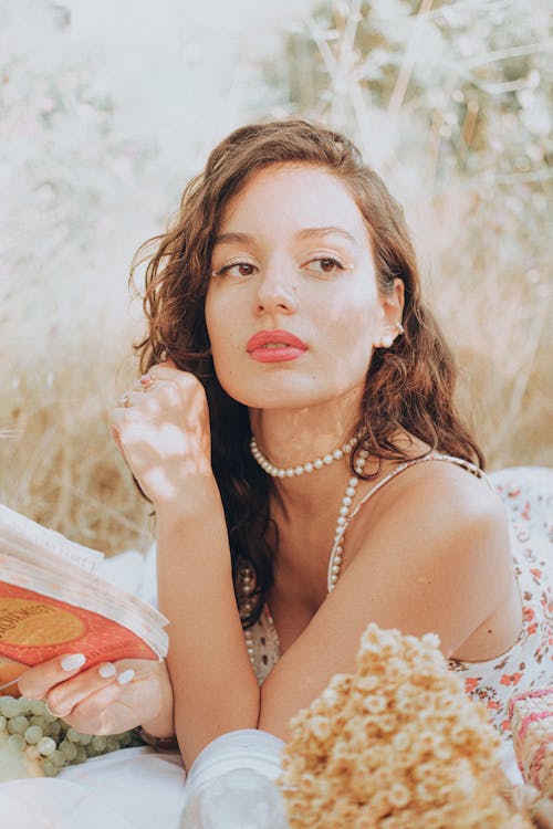 Free A Woman Holding a Book Stock Photo