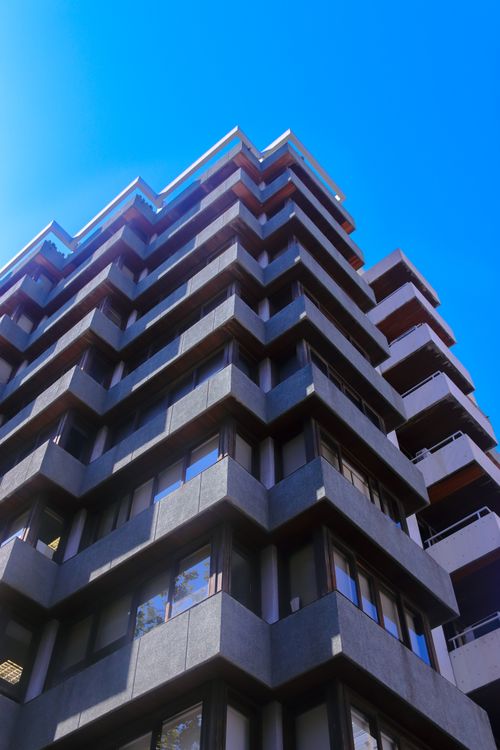 Free A striking view of a modern office building against a clear blue sky in Valencia, Spain. Stock Photo