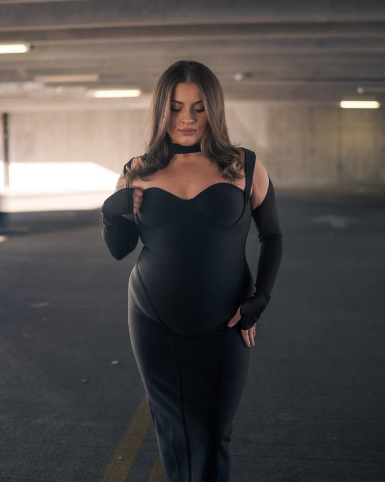 Woman In Black Bodysuit Standing In Parking