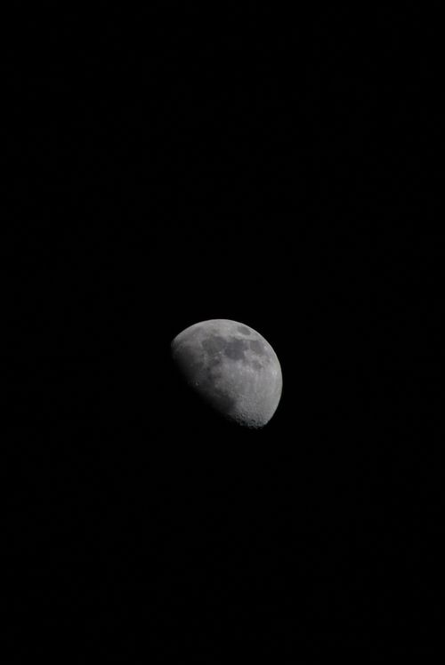 Free A stunning view of the moon in a vivid black sky, capturing its detailed crater surface. Stock Photo