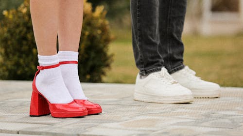 Legs of Man and Woman in Shoes and High Heels