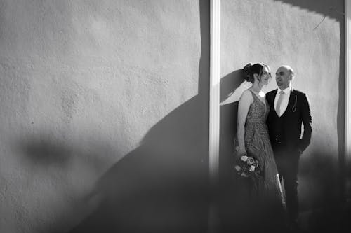 Couple Standing Together by Wall