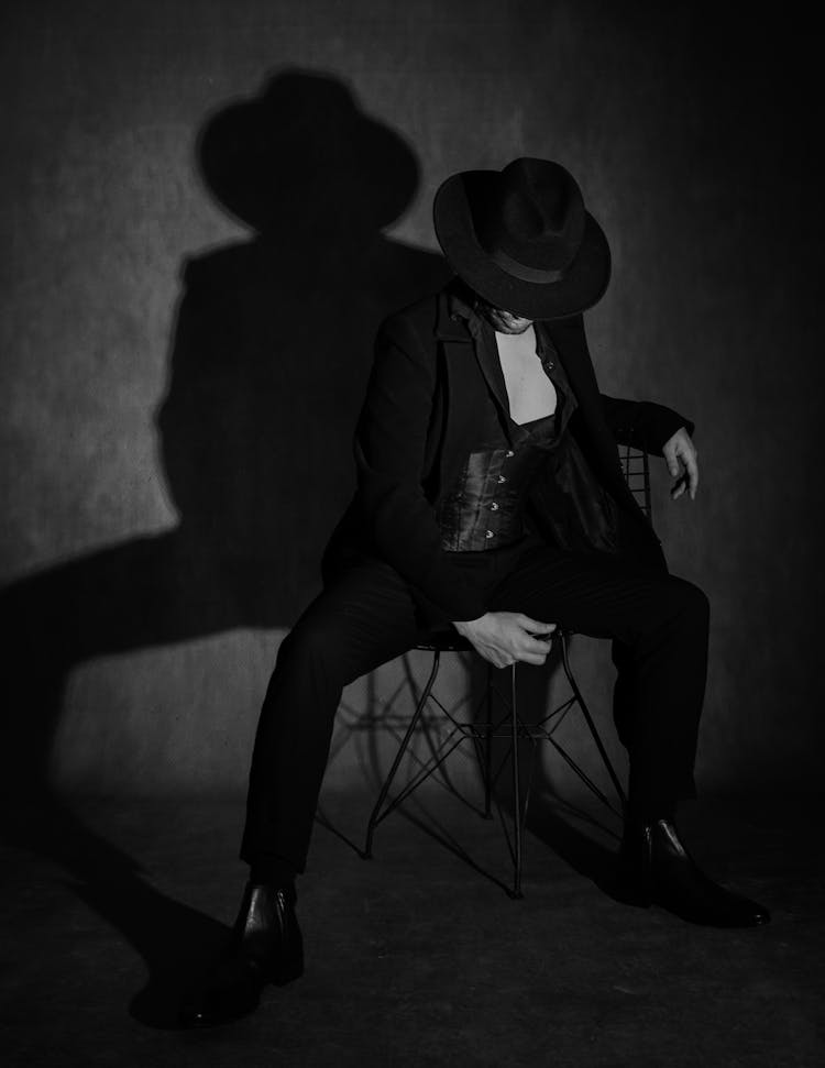 Black And White Photo Of A Man In Black Suit And Felt Hat