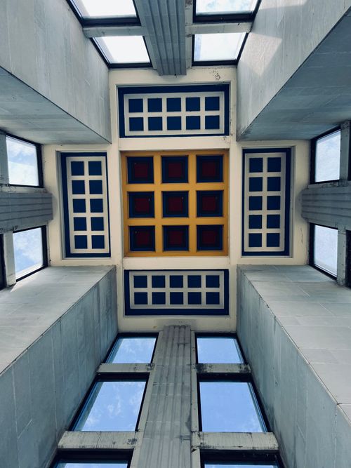 Free A striking view of a modern architectural ceiling with geometric squares and large windows. Stock Photo