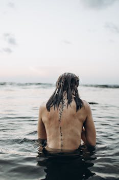 A person enjoys a quiet moment in the sea at sunset, capturing relaxation and tranquility in Türkiye.