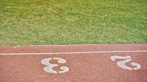 Image of a running track with lanes 2 and 3 clearly marked, perfect for sports concepts.