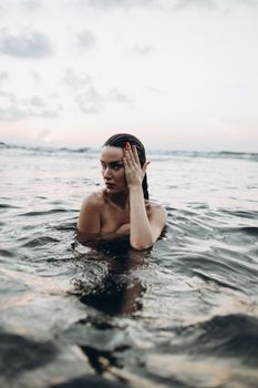 A serene image of a woman relaxing in the ocean at sunset, capturing the beauty of outdoor leisure.