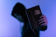 Person Holding Bible