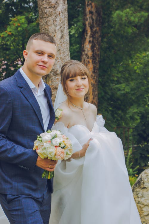 Smiling Newlyweds with Bouquet