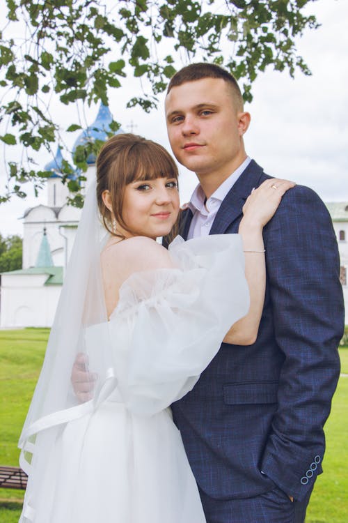 Newlyweds Standing and Hugging