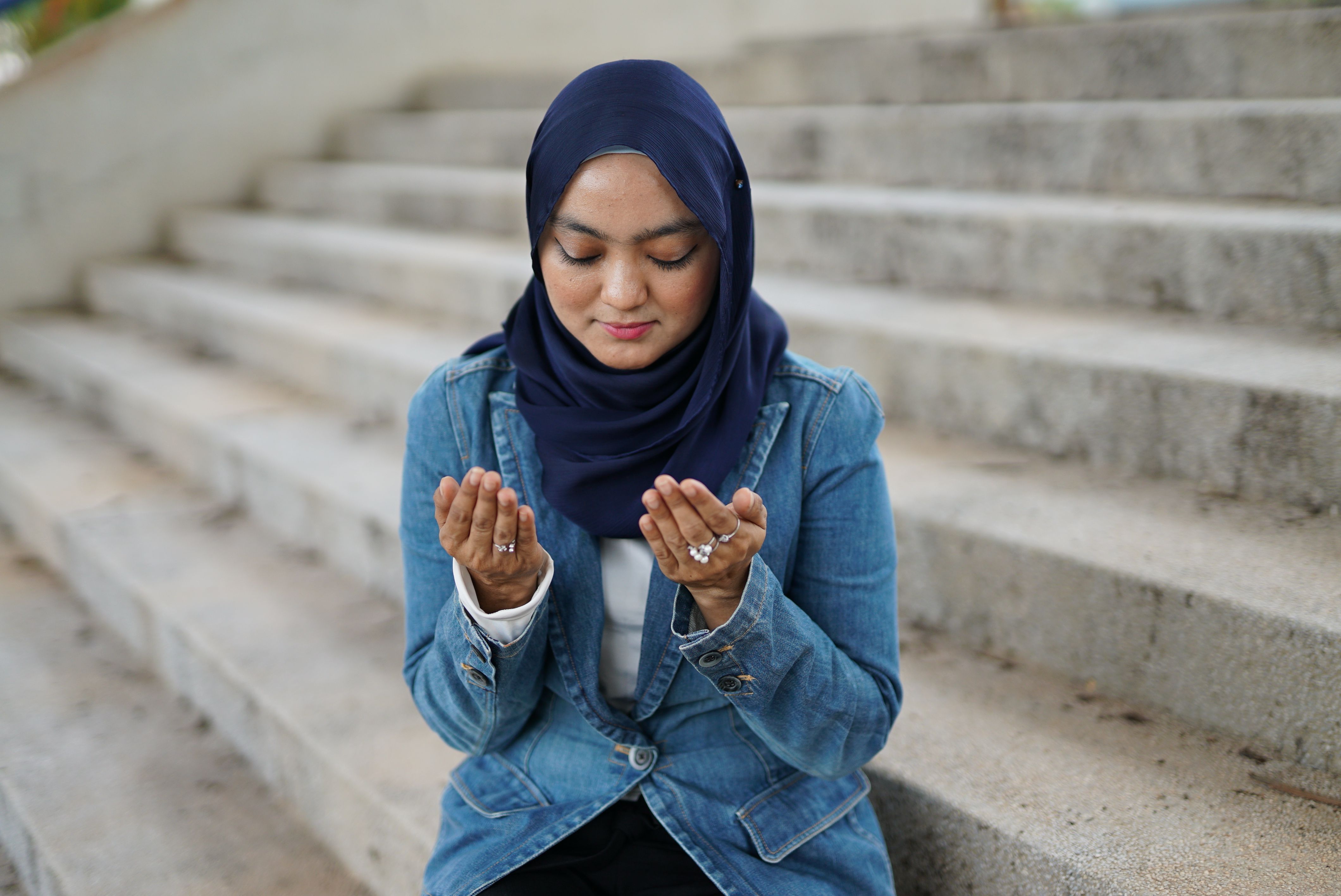 Young Woman in a Hijab Sitting on Steps · Free Stock Photo