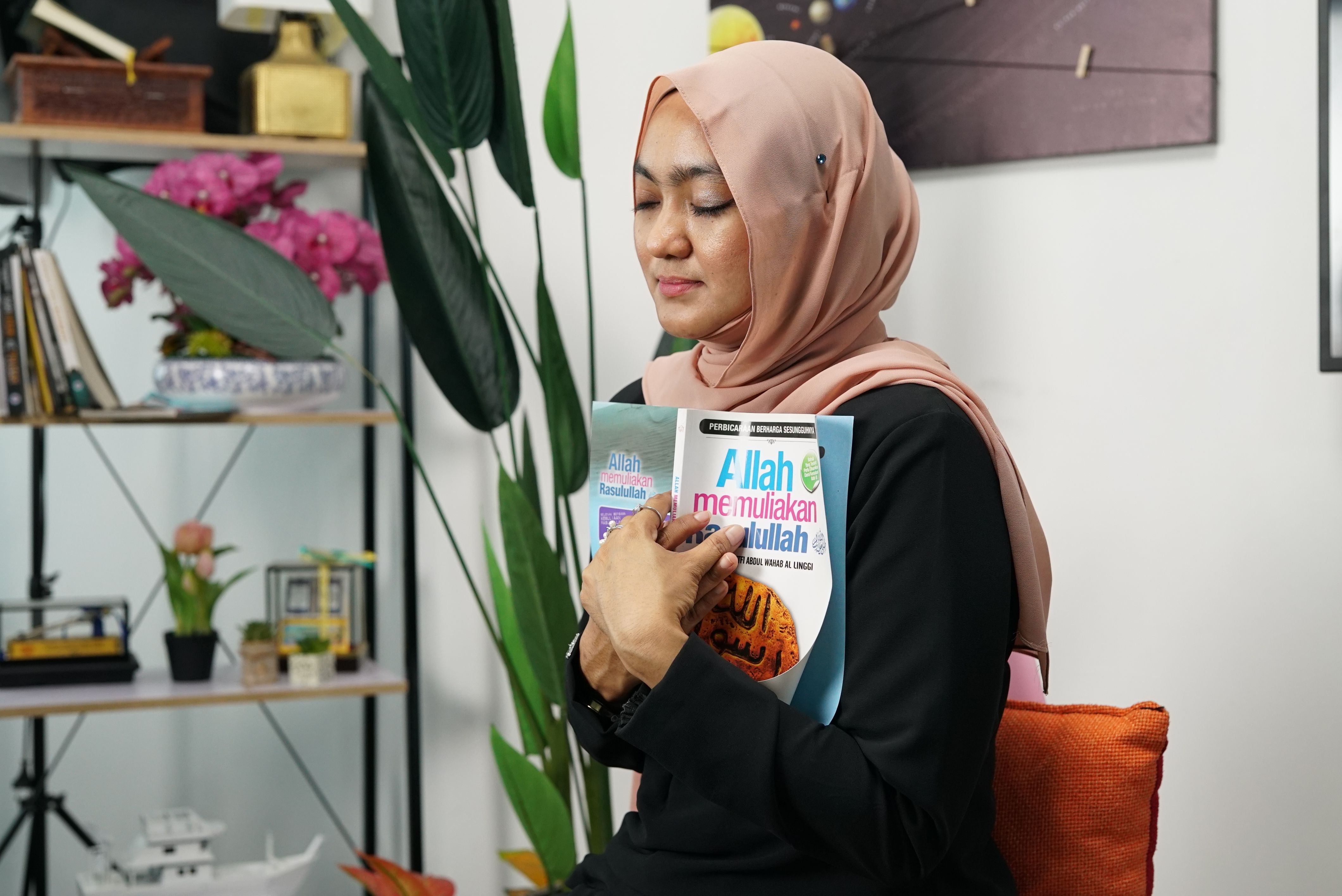 Young Woman in a Hijab Holding a Book · Free Stock Photo