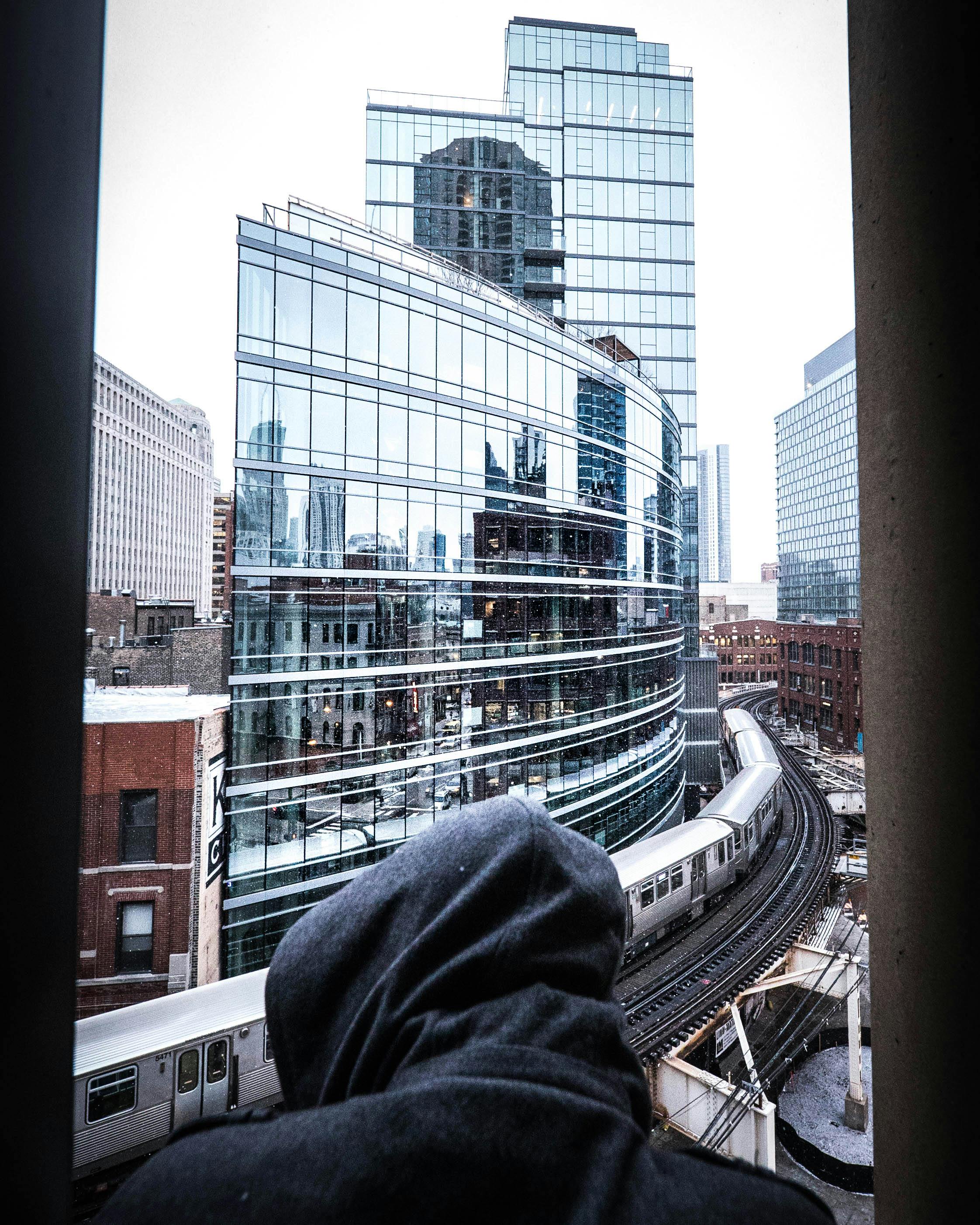 A diverse group of people sit in a circle during a therapy session, listening intently.