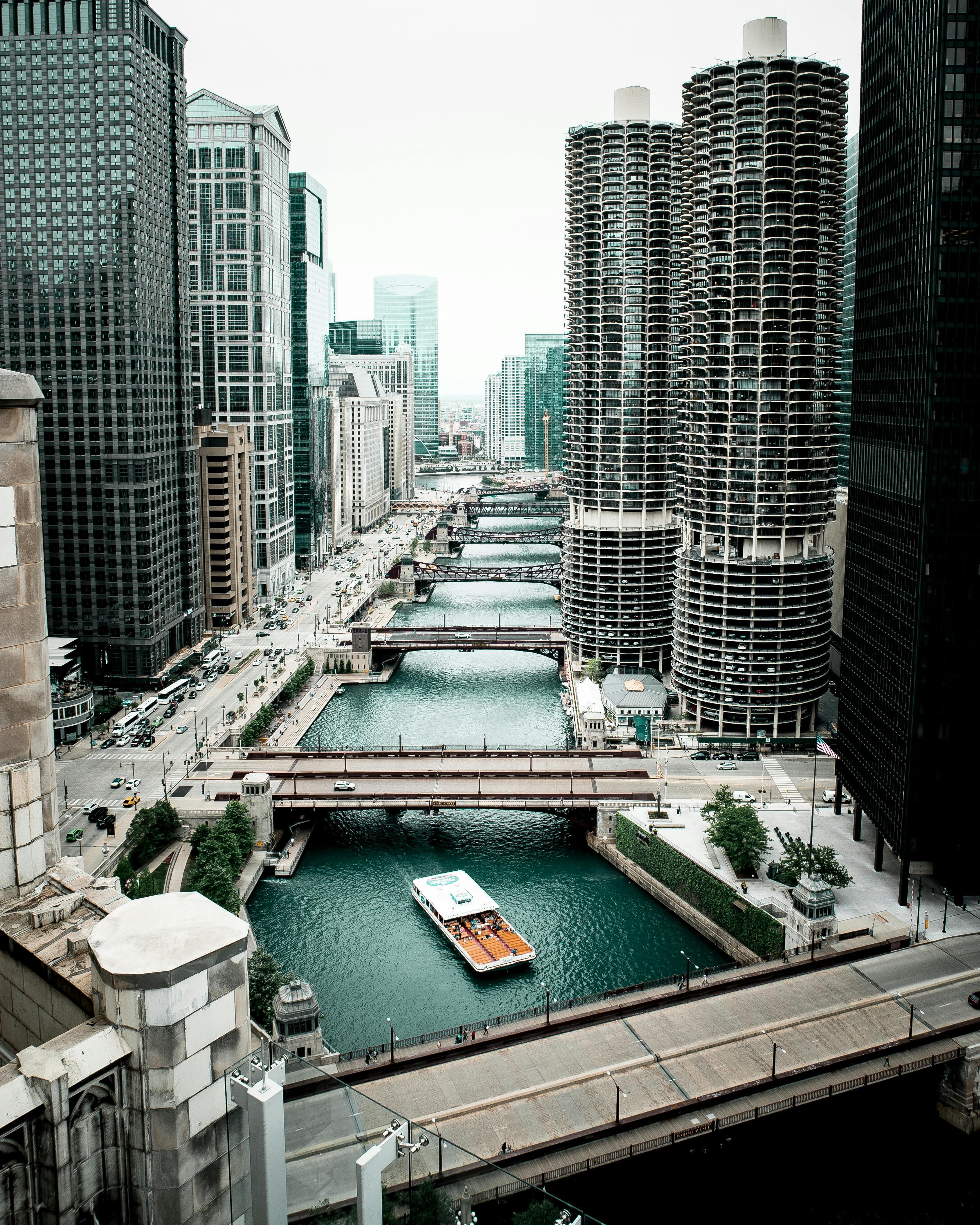 Boat Sailing on Sea Canal in Between High-rise Buildings