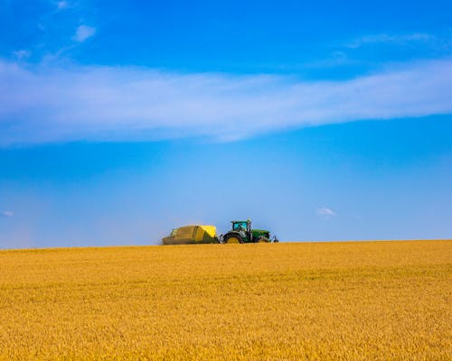 Free Tractor on a Wheat Field Stock Photo