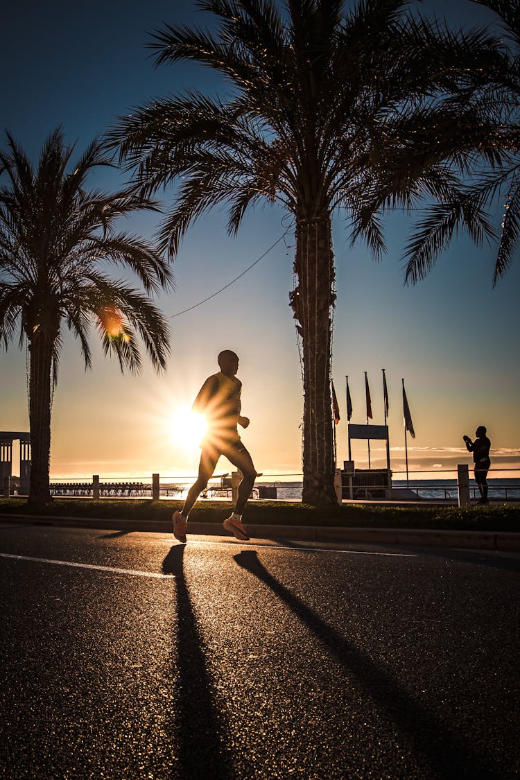 Man Running On Street At Sunset