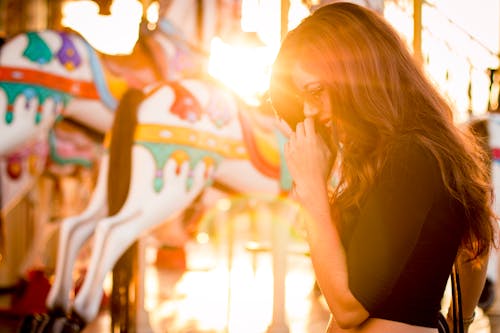 Woman Standing in Front of Carousel