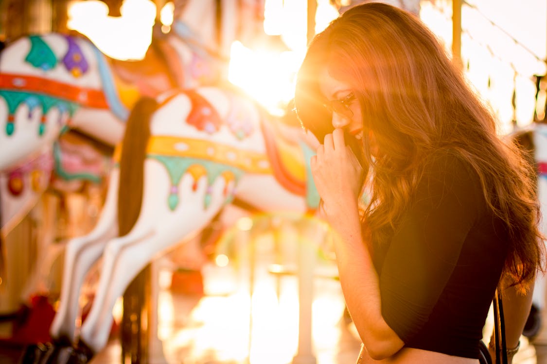 Woman Standing in Front of Carousel