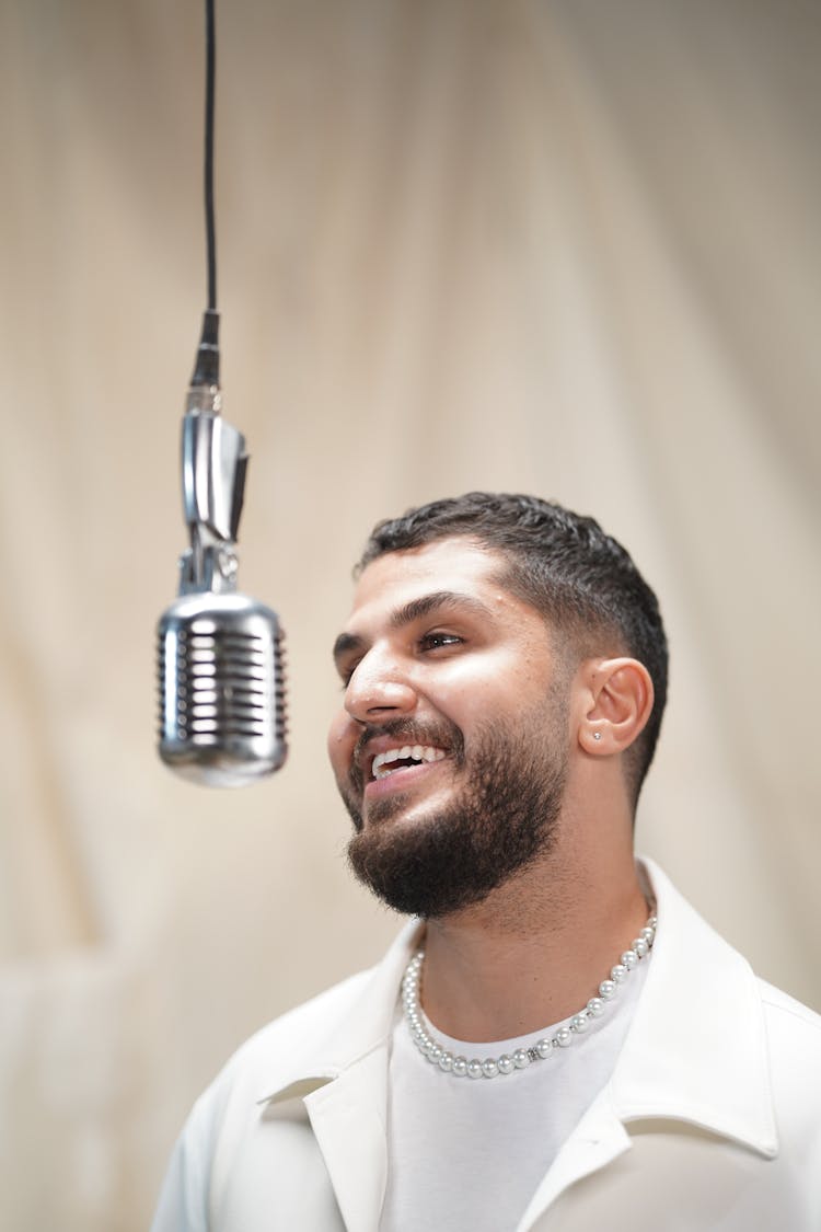 Smiling Singer With Microphone In Studio