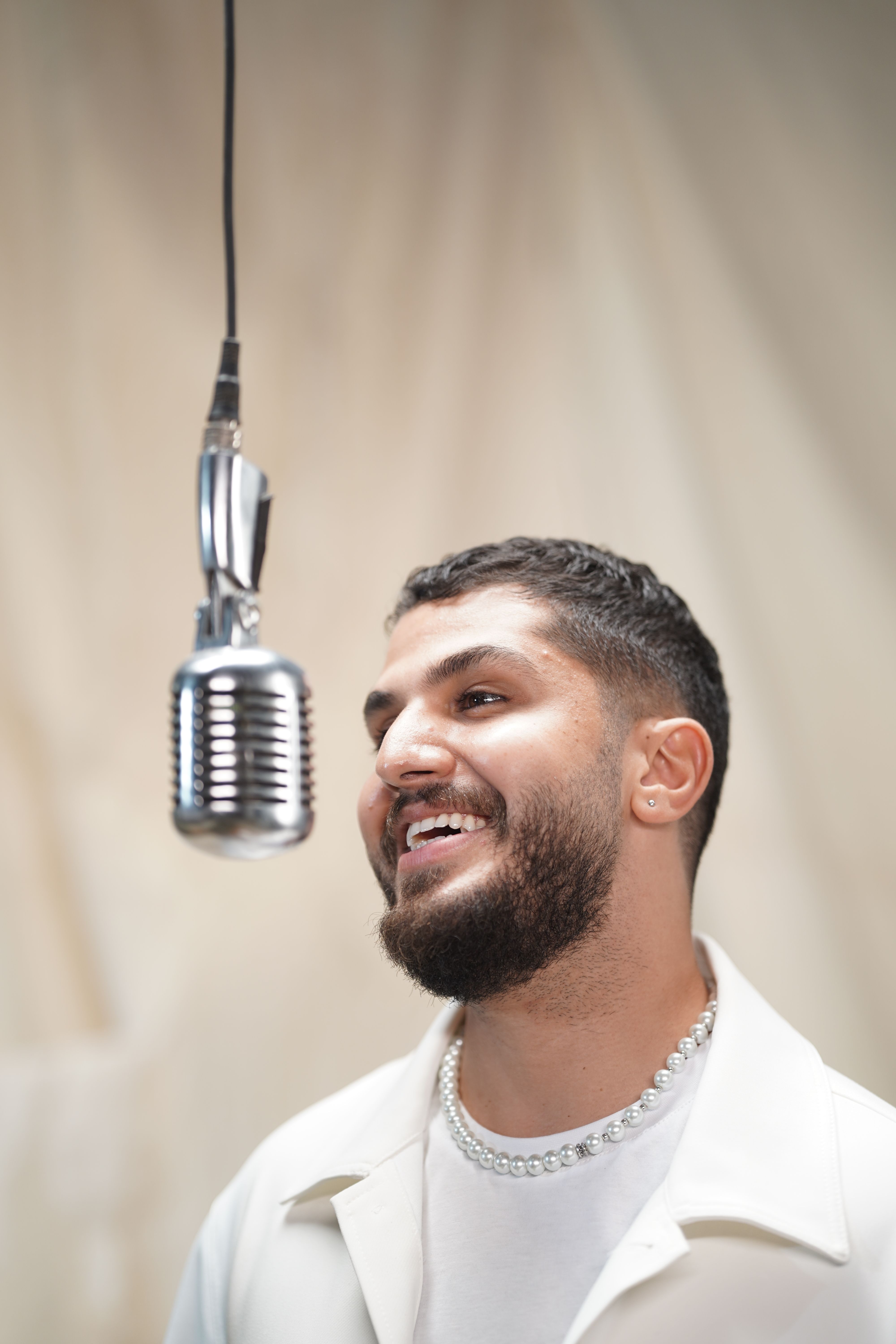 Smiling Singer with Microphone in Studio · Free Stock Photo
