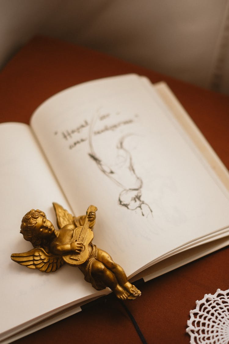 Gold Figure Of Angel On Book