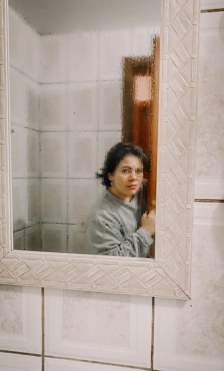 Blurred Reflection Of Woman In Mirror