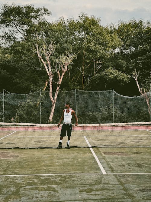 Man Standing on Tennis Court