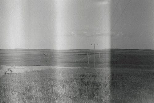 Black and White Film Photo of Fields in the Countryside 