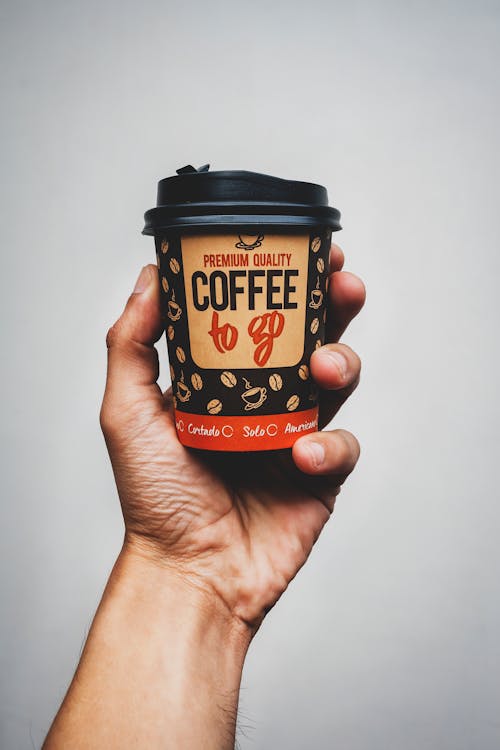 Hand Holding Paper Coffee Cup