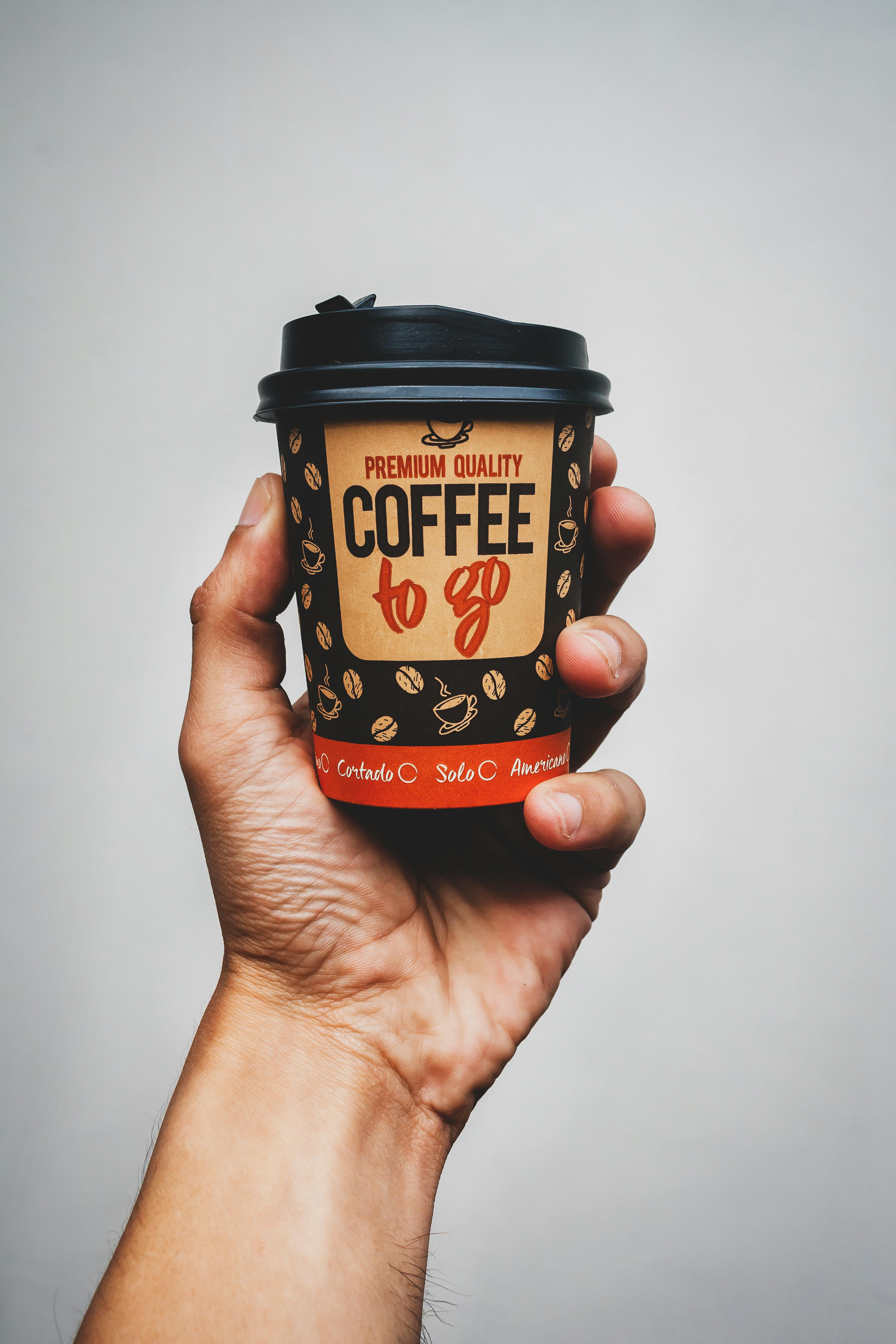 Hand Holding Paper Coffee Cup · Free Stock Photo