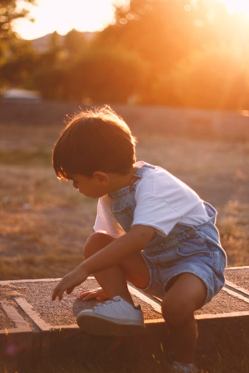 Boy in Denim Overalls