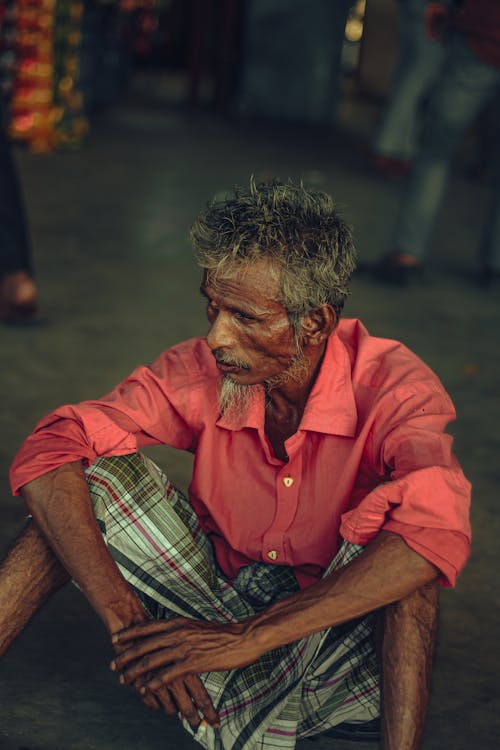 Elderly Man in Shirt Sitting