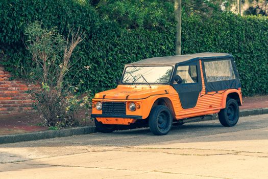 Orange antique car on the street