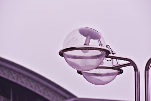 Free Close-up of modern globe lamps on a steel structure under overcast sky. Stock Photo