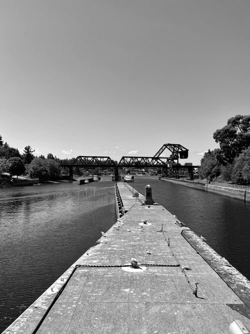 Free Monochrome view of a historic railway bridge over a river in Seattle. Stock Photo