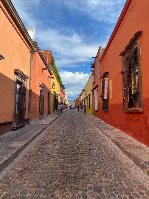 Free Vibrant cobblestone street in San Miguel de Allende, Mexico with colorful colonial architecture. Stock Photo
