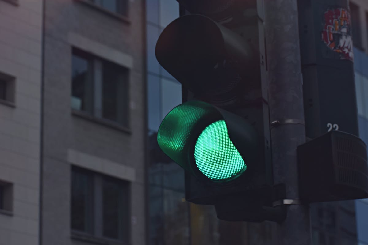 Black Traffic Light Displaying Green Go Signal 