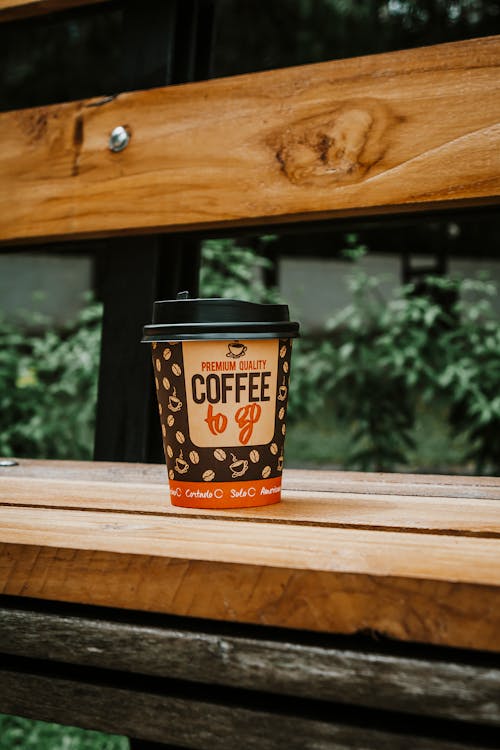 Disposable Cup of Coffee on Wooden Bench