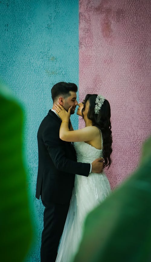 Newlyweds Standing and Kissing