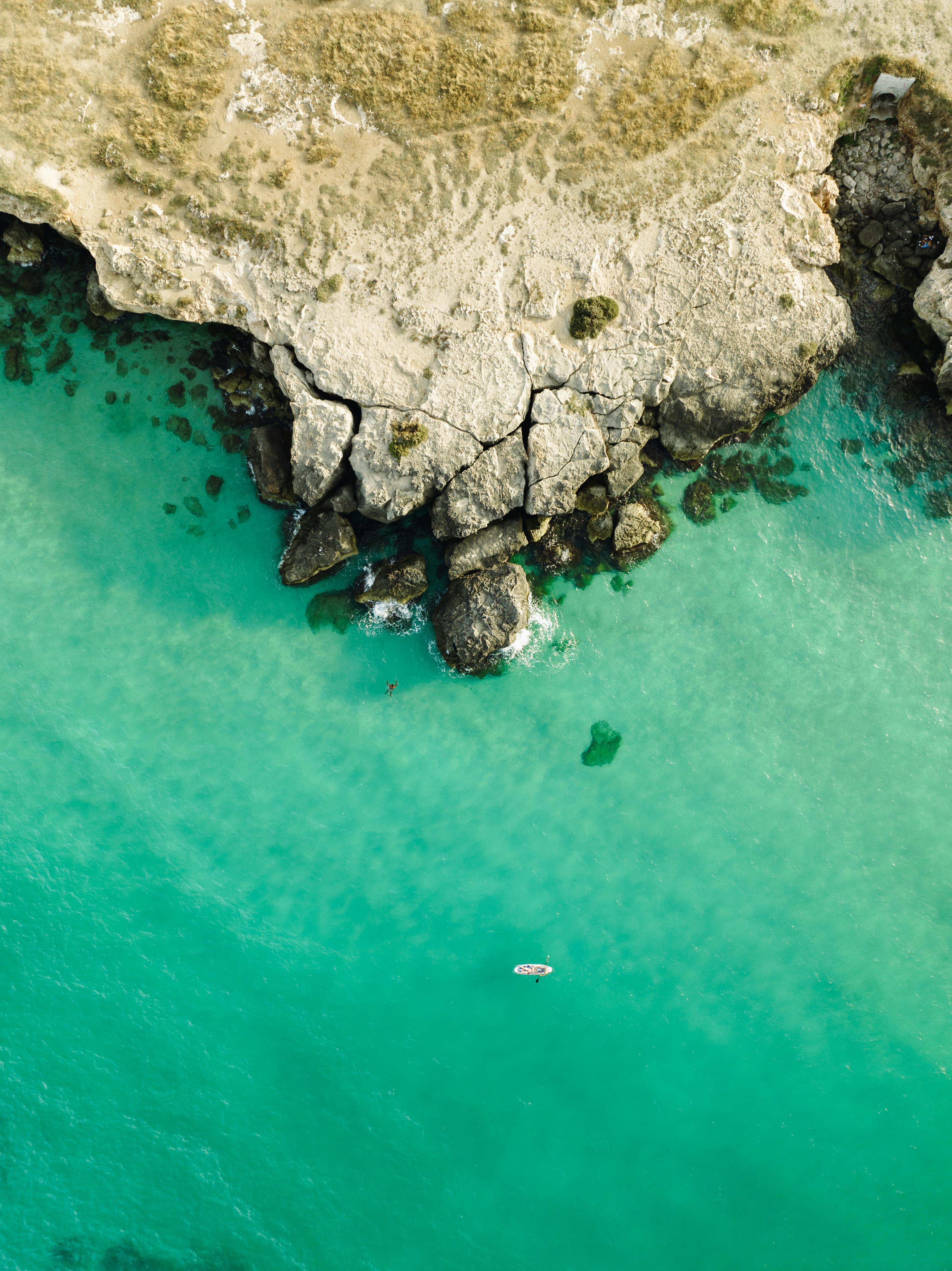 Stunning aerial shot of the rocky coastline and turquoise waters at Monopoli, Italy.