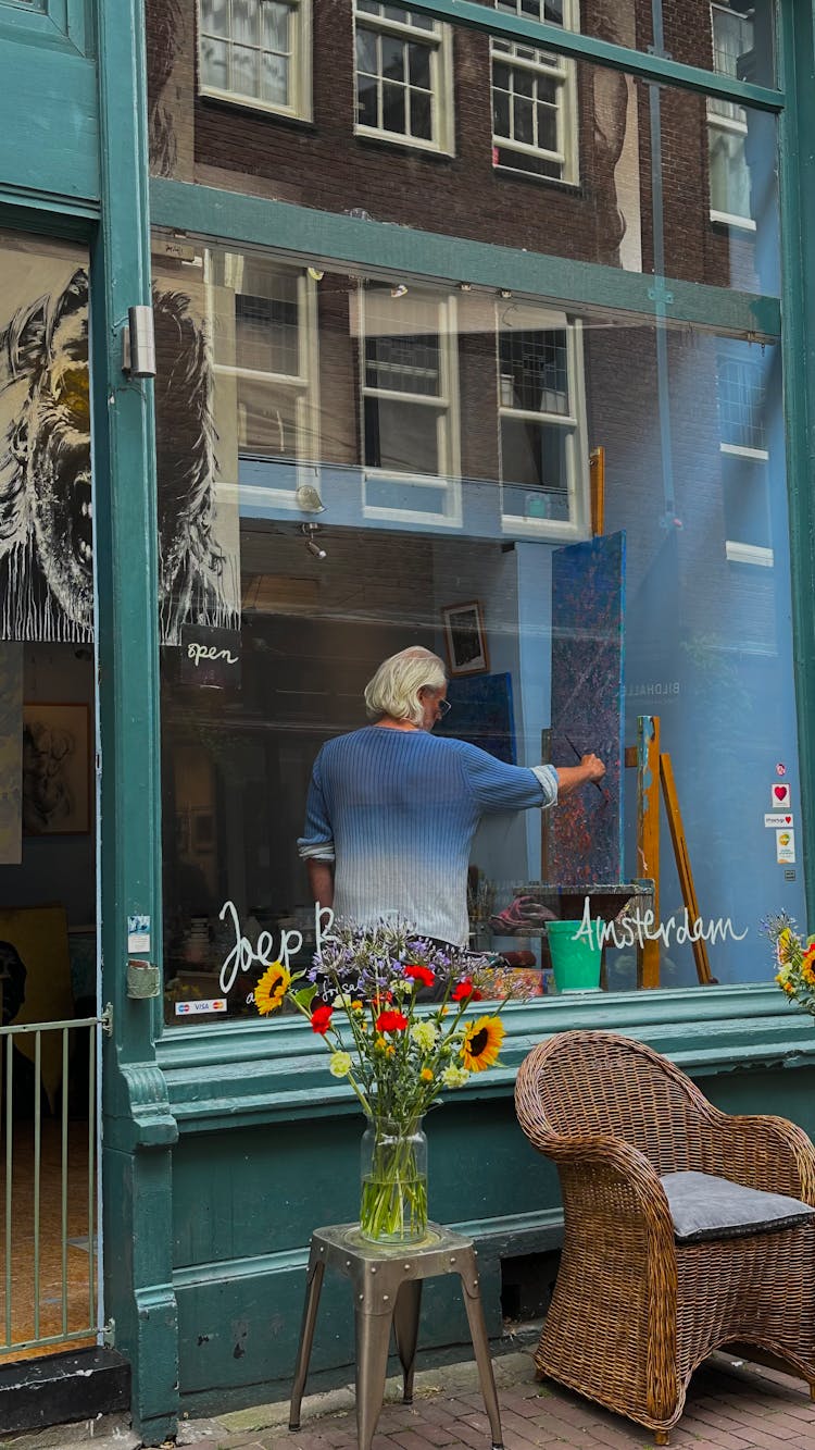 Artist Painting Behind Window