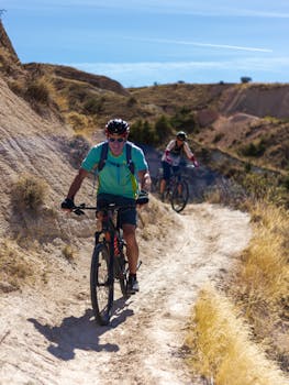 Two cyclists navigating a picturesque trail in Türkiye, showcasing outdoor adventure and fitness.