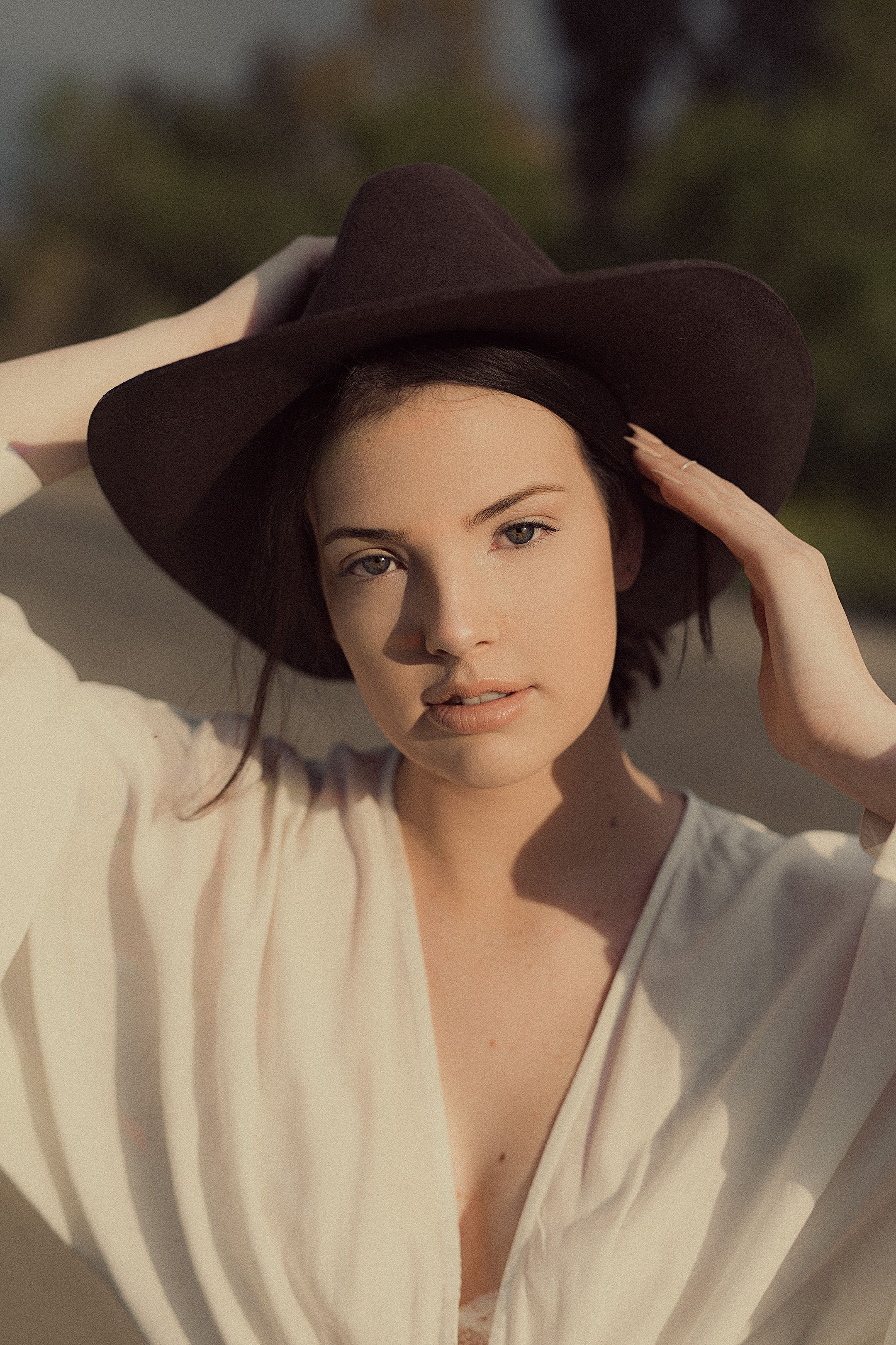 Elegant portrait of a woman in a hat, perfect for lifestyle and fashion imagery.